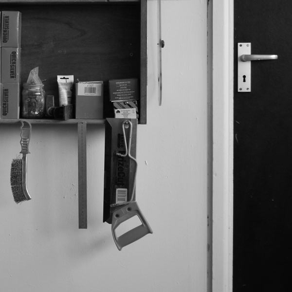 A Saw and some woodworking tools hanging in the Boot & Saw Workshop
