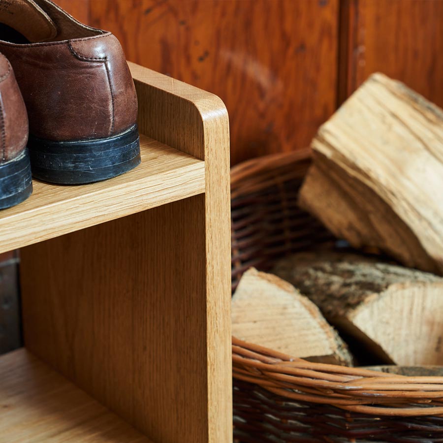 Close up detail of an Oak Shoe Rack next to a log basket, part of our Oak Shoe Rack Collection