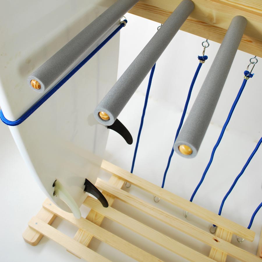 Close up of a wooden Surfboard rack with blue straps, part of our Surfboard Rack Collection