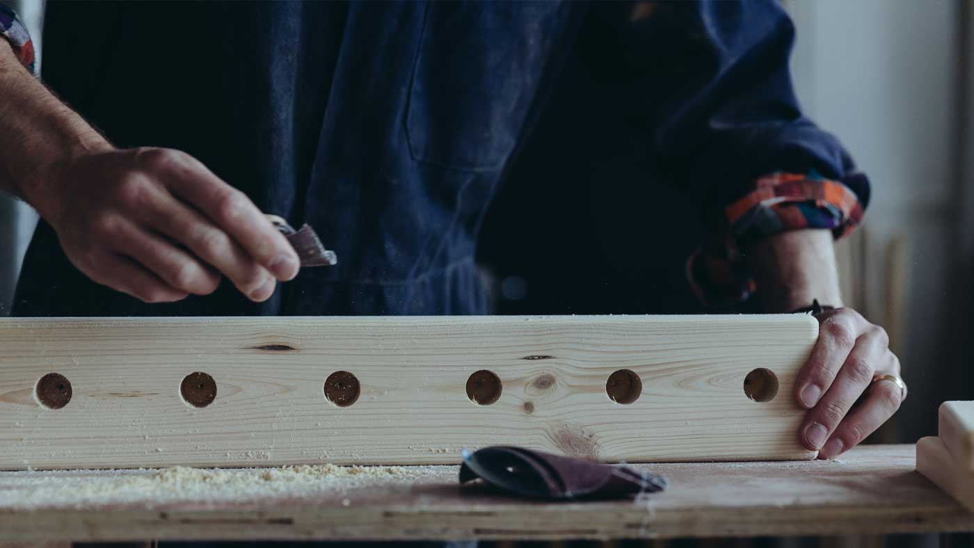 Hand sanding a wellington rack