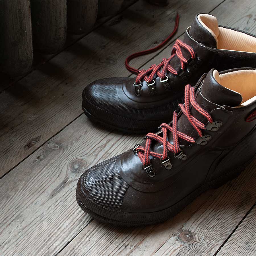 A pair of Harris Dryboots on a wooden floor, part of our Footwear Collection