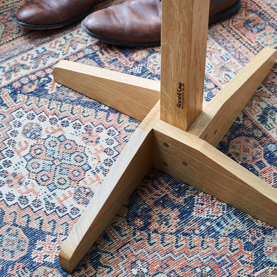 Close up of an Oak Coat Stand on a patterned rug, part of our Oak Coat Stand Collection